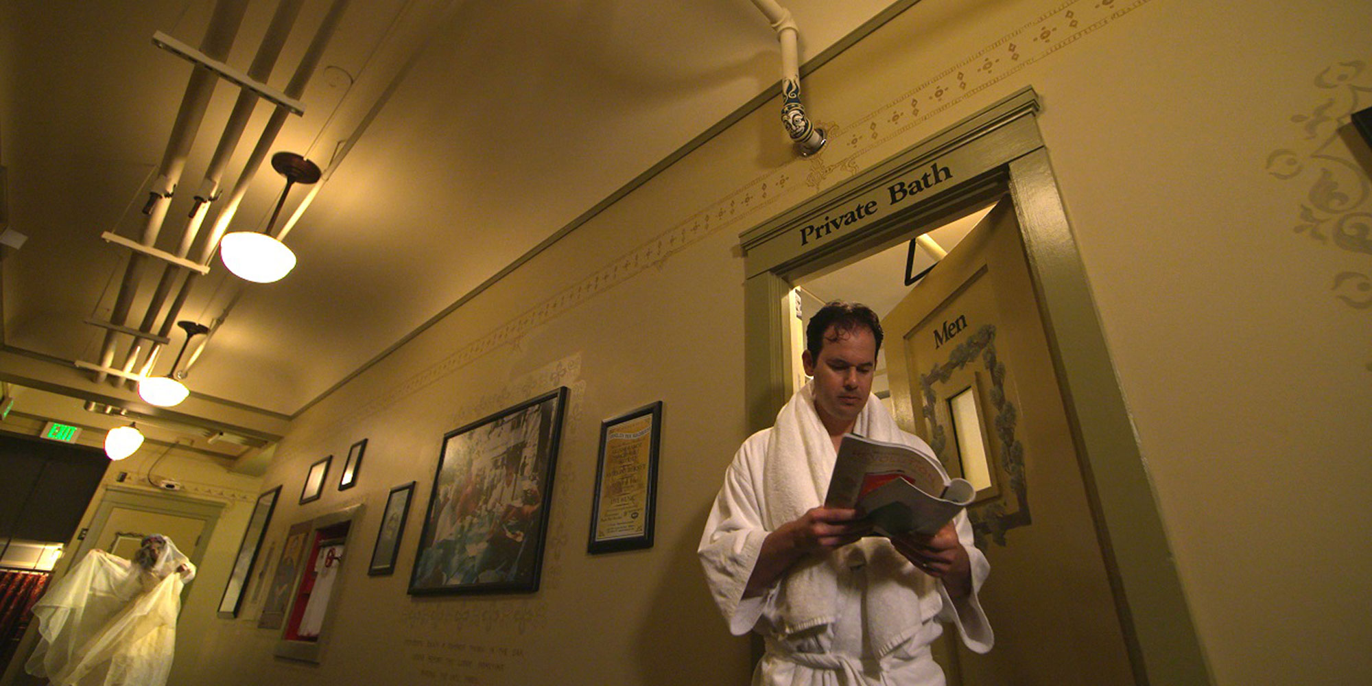 man reading in a hall after leaving spa, a ghost in the hallway