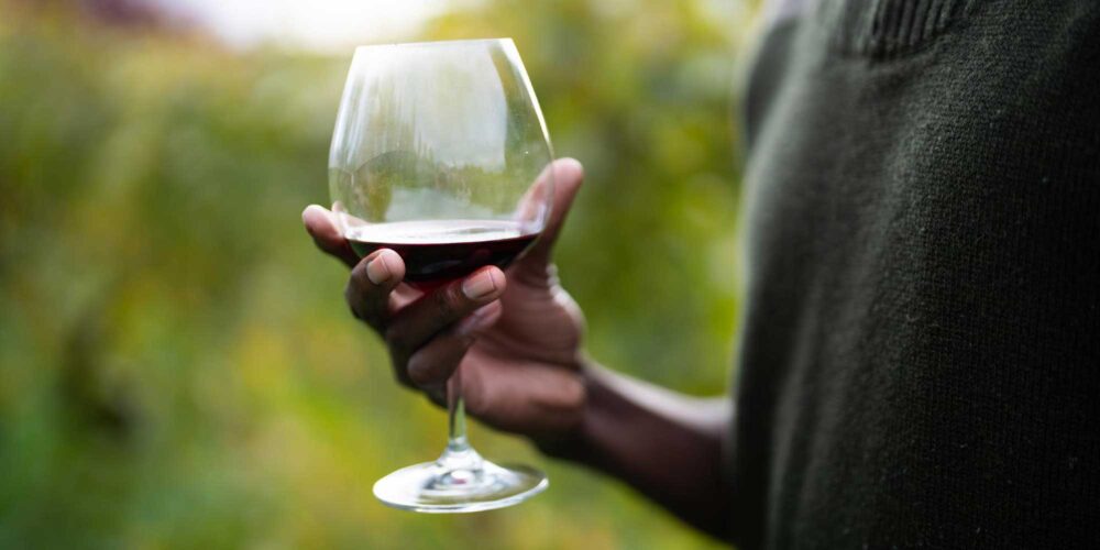 man holding a glass of red wine